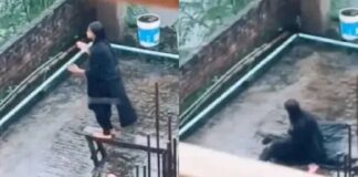 A mobile phone set on a tripod with a broken stool beside it, representing the exact accident moment without showing the girl falling A mobile phone set on a tripod with a broken stool beside it, representing the exact accident moment without showing the girl falling