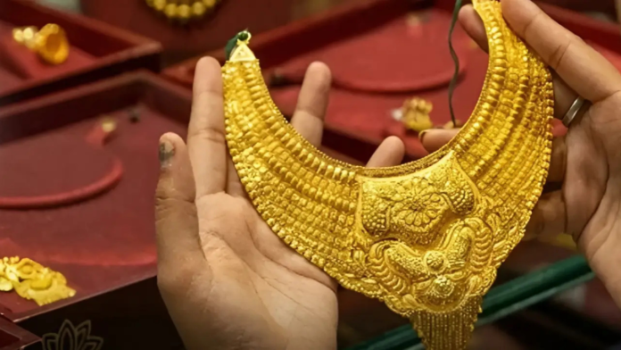 On Sunday, the rate for 24 carat gold stands at Rs 1,48,220 per 10 grams and the price of silver is Rs 2,45,000 per kilogram.